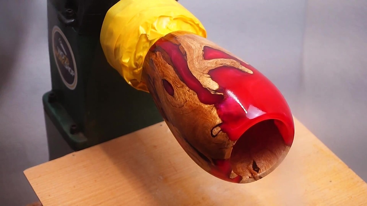 Plum tree root becomes a glossy red resin vase