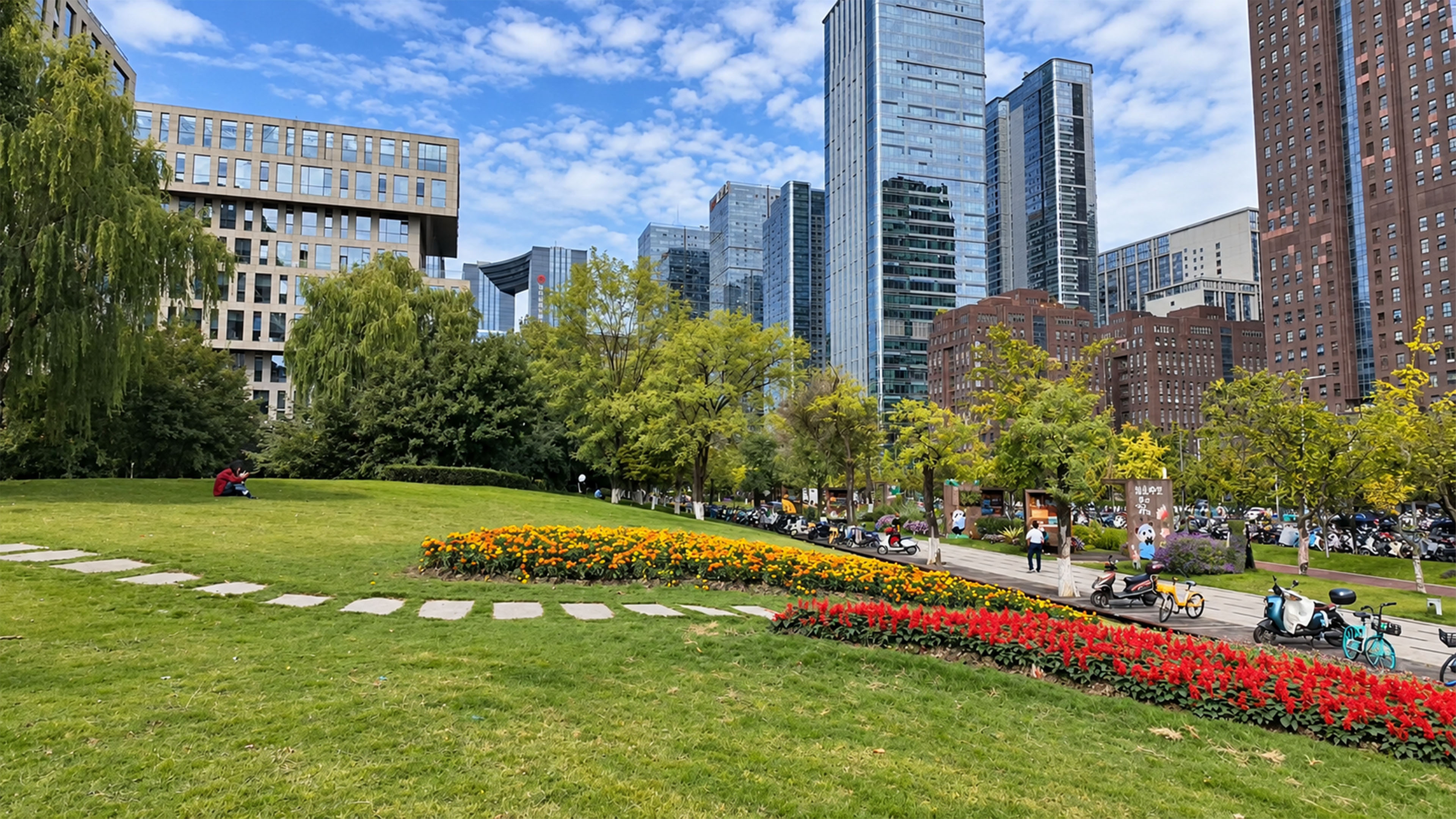A colorful flower garden sits beneath China's glass skyscrapers