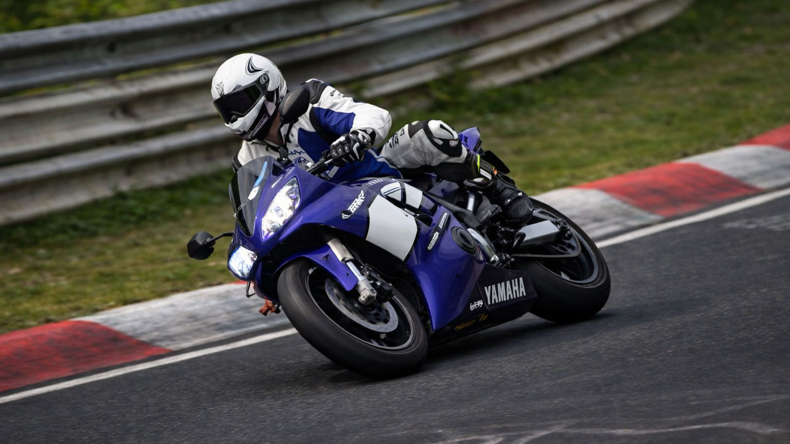Yamaha sportbike leans deep into a Nürburgring corner
