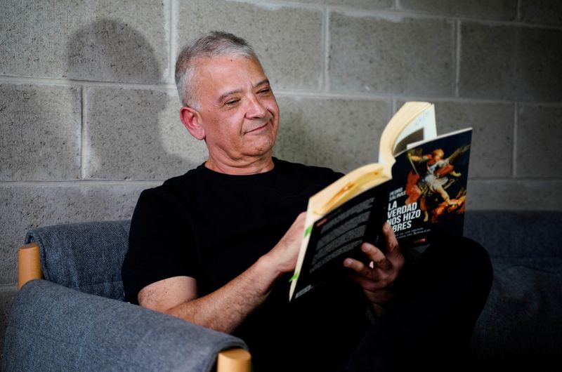 Pedro Salinas, a Peruvian journalist and abuse survivor, poses for a photo with his book La Verdad Nos Hara Libres at his home ahead of Pope Leo’s November 6-17 visit to Uruguay, Argentina and Peru, during which he is expected to meet abuse survivors, in Lima, Peru, October 21, 2026. REUTERS/Leslie Moreno