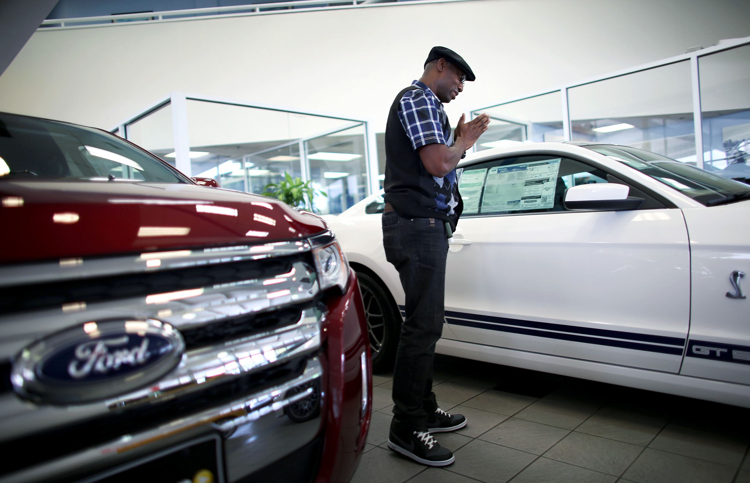 Anthony Gordon looks at a Ford Mustang on the showroom floor at a Ford AutoNation car dealership in North Miami, Florida. 