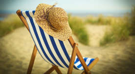 Sun hat on chair on beach