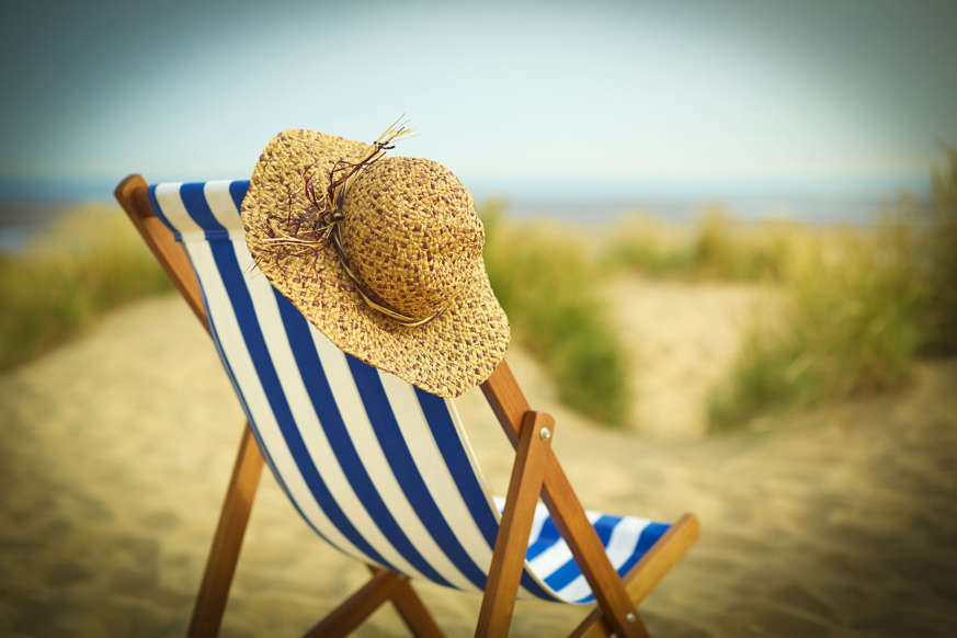 Sun hat on chair on beach