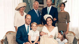 Cheeky George steals the show as he sits on Prince William's lap, while Prince Charles, Duchess Camilla, Prince Harry and the Duchess of Sussex stand proudly behind the 11-week-old.