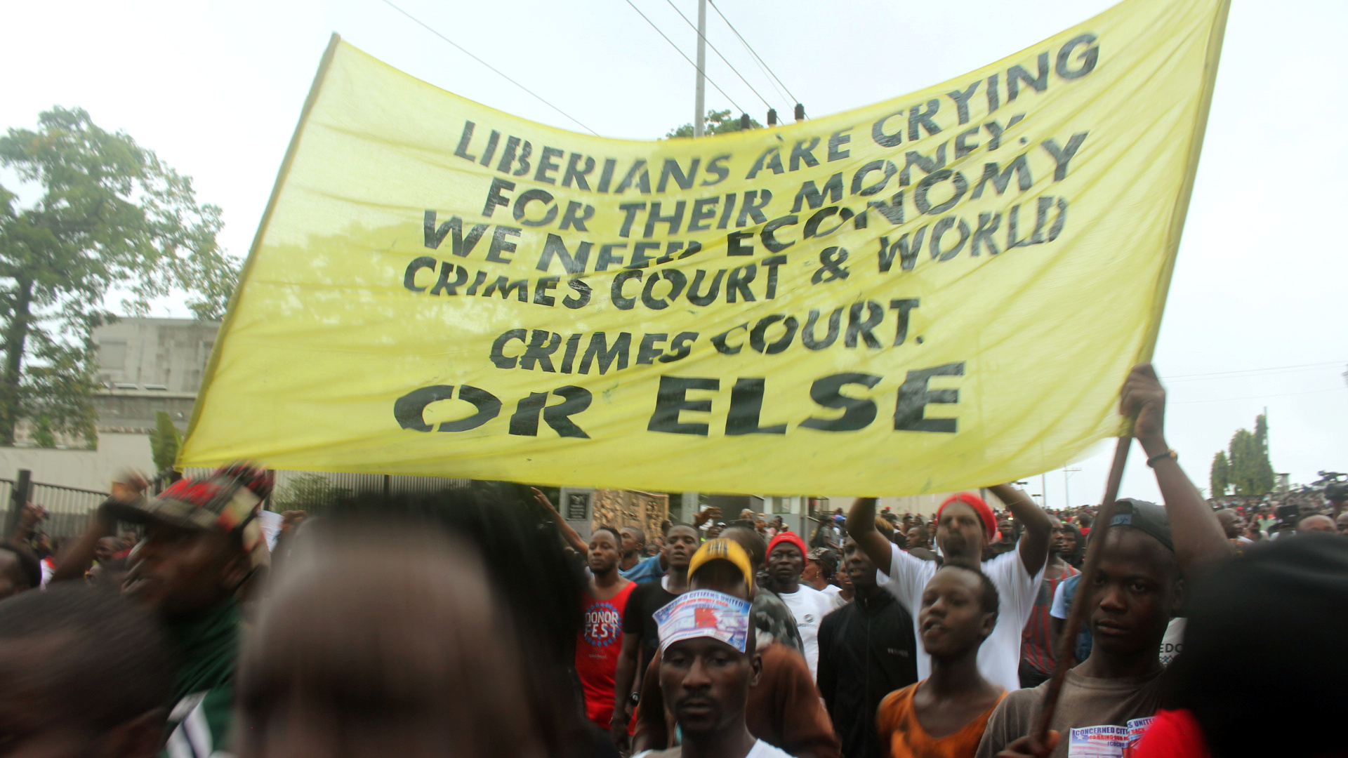 Liberian demonstrators hold a banner during a protest in Monrovia, Liberia September 24, 2018.