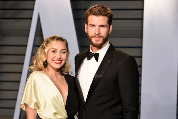 Slide 1 of 25: BEVERLY HILLS, CA - MARCH 04:  Miley Cyrus and Liam Hemsworth attend the 2018 Vanity Fair Oscar Party Hosted By Radhika Jones - Arrivals at Wallis Annenberg Center for the Performing Arts on March 4, 2018 in Beverly Hills, CA.  (Photo by Presley Ann/Patrick McMullan via Getty Images)