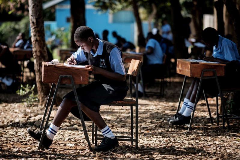 Students of St Dominic Bukna Secondary school take their English test outside due to their overcrowded class room in Kisumu, Kenya, on May 31, 2018.