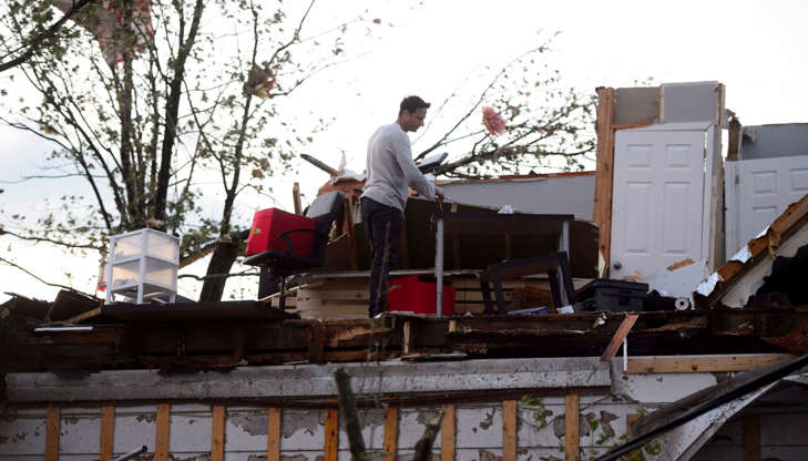 People collect personal effects from damaged homes following a tornado in Dunrobin, Ont. west of Ott... - THE CANADIAN PRESS/Sean Kilpatrick Slide 13 of 21: People collect personal effects from damaged homes following a tornado in Dunrobin, Ont. west of Ottawa on Sept. 21, 2018.