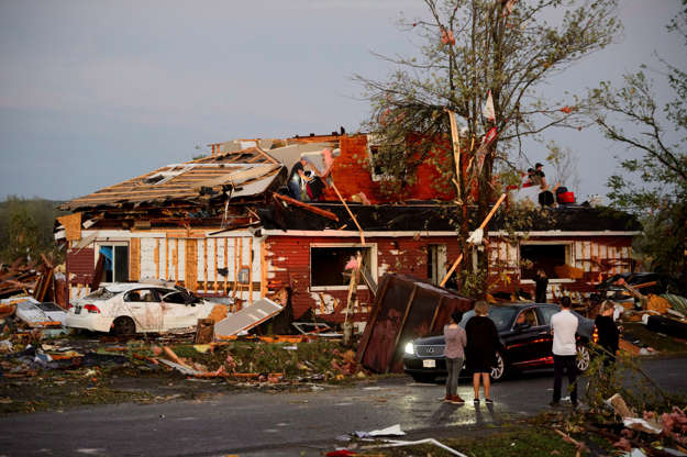 People collect personal effects from damaged homes following a tornado in Dunrobin, Ont. west of Ott... - Sean Kilpatrick/The Canadian Press via AP Slide 14 of 21: People collect personal effects from damaged homes following a tornado in Dunrobin, Ont. west of Ottawa on Sept. 21, 2018. A tornado damaged cars in Gatineau, Que., and houses in a community west of Ottawa on Friday afternoon as much of southern Ontario saw severe thunderstorms and high wind gusts, Environment Canada said.