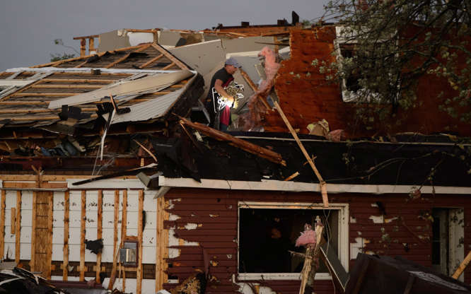 People collect personal effects from damaged homes following a tornado in Dunrobin, Ont. west of Ott... - THE CANADIAN PRESS/Sean Kilpatrick Slide 2 of 21: People collect personal effects from damaged homes following a tornado in Dunrobin, Ont. west of Ottawa on Sept. 21, 2018.