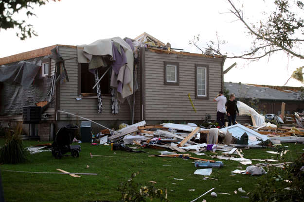 A young couple surveys the damage to their home following a tornado in Dunrobin, Ont. west of Ottawa... - THE CANADIAN PRESS/Sean Kilpatrick Slide 1 of 21: A young couple surveys the damage to their home following a tornado in Dunrobin, Ont. west of Ottawa on Sept. 21, 2018. A tornado damaged cars in Gatineau, Que., and houses in a community west of Ottawa on Friday afternoon as much of southern Ontario saw severe thunderstorms and high wind gusts, Environment Canada said.