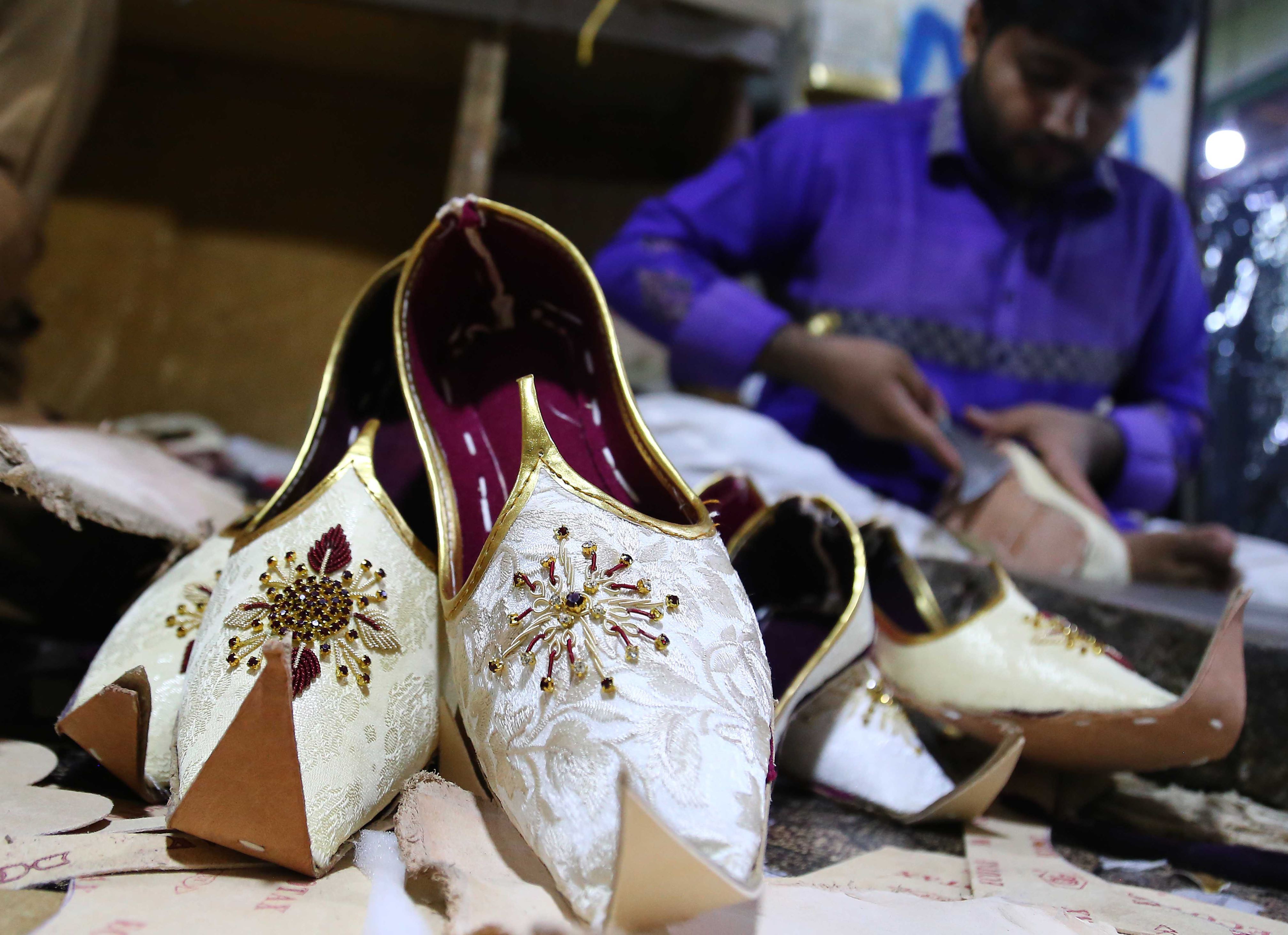 Slide 1 of 127: A Pakistani cobbler makes traditional Khussa shoes ahead of the Eid al-Fitr festival marking the end of holy fasting month of Ramadan, in Karachi, Pakistan, 28 May 2019. Muslims around the world are preparing to celebrate Eid al-Fitr, the three day festival marking the end of the Muslim holy month of Ramadan, it will be observed on 4th or 5th of June depending on the lunar calendar. Eid al-Fitr is one of the two major holidays in Islam.