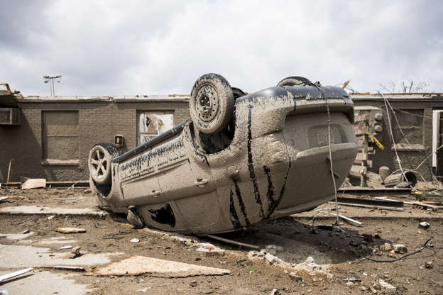 Slide 5 of 75: Mandatory Credit: Photo by Megan Jelinger/SOPA Images/REX/Shutterstock (10255776e) Aftermath of tornado in Dayton, Western Ohio Tornado hits Ohio, USA - 29 May 2019 A car is seen flipped over after a tornado struck the area the night before. At least one person is dead and twelve are injured due to the storms that hit western Ohio.