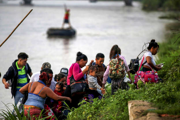 Slide 4 of 75: Central American migrants get off a raft after crossing the Suchiate river from Tecun Uman, in Guatemala, to Ciudad Hidalgo, as seen from Ciudad Hidalgo, Mexico, June 8, 2019.