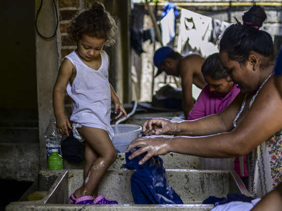 Slide 2 of 75: Migrants in the hopes of reaching the United States wash clothes by hand at a shelter in Tapachula, Chiapas state, Mexico, on June 8, 2019. - The United States and Mexico reached an 11th-hour deal late Friday to crack down on migration from Central America, with President Donald Trump relenting on threats to slap potentially devastating tariffs on Mexican goods. The crackdown has made reaching the United States an increasingly impossible dream for migrants as Mexico has increased migrant detentions, restricted visas, stepped up military and police patrols and agreed to deploy 6,000 members of its new National Guard to reinforce the border area.