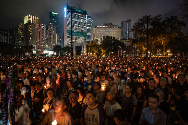 Slide 2 of 31: HONG KONG, HONG KONG - JUNE 04: People hold candles as they take part in a candlelight vigil at Victoria Park on June 4, 2019 in Hong Kong, China. As many as 180,000 people are expected to attend a candlelight vigil in Hong Kong on Tuesday during the 30th anniversary of the Tiananmen Square massacre as commemorations took place in cities around the world on June 4 to remember those who died when Chinese troops cracked down on pro-democracy protesters. Thirty years ago, the People's Liberation Army opened fire and killed from hundreds to thousands of protesters in Beijing after hundreds of thousands of students and workers gathered in Tiananmen Square for weeks to call for greater political freedom. No-one knows for sure how many people were killed as China continues to censor any coverage or discussion of the event that takes place during the anniversary.  (Photo by Anthony Kwan/Getty Images)