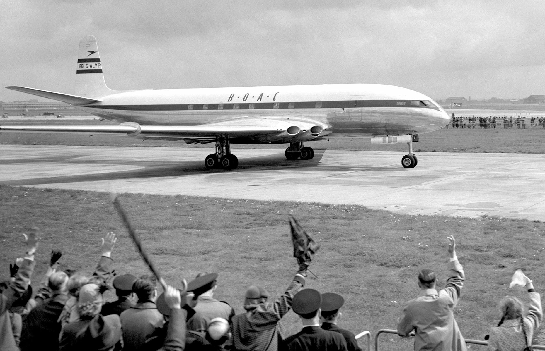 Slide 17 of 51: Commercial air travel boomed through the 1950s and, for the first time in history, more US passengers were traveling by air than train. The 1950s also ushered in the "jet age". The de Havilland DH 106 Comet became the world's first commercial jet airliner, debuting in 1952 with the British Overseas Airways Corporation (BOAC). Here, crowds are seen waving the aircraft off as it leaves London for Johannesburg, South Africa.