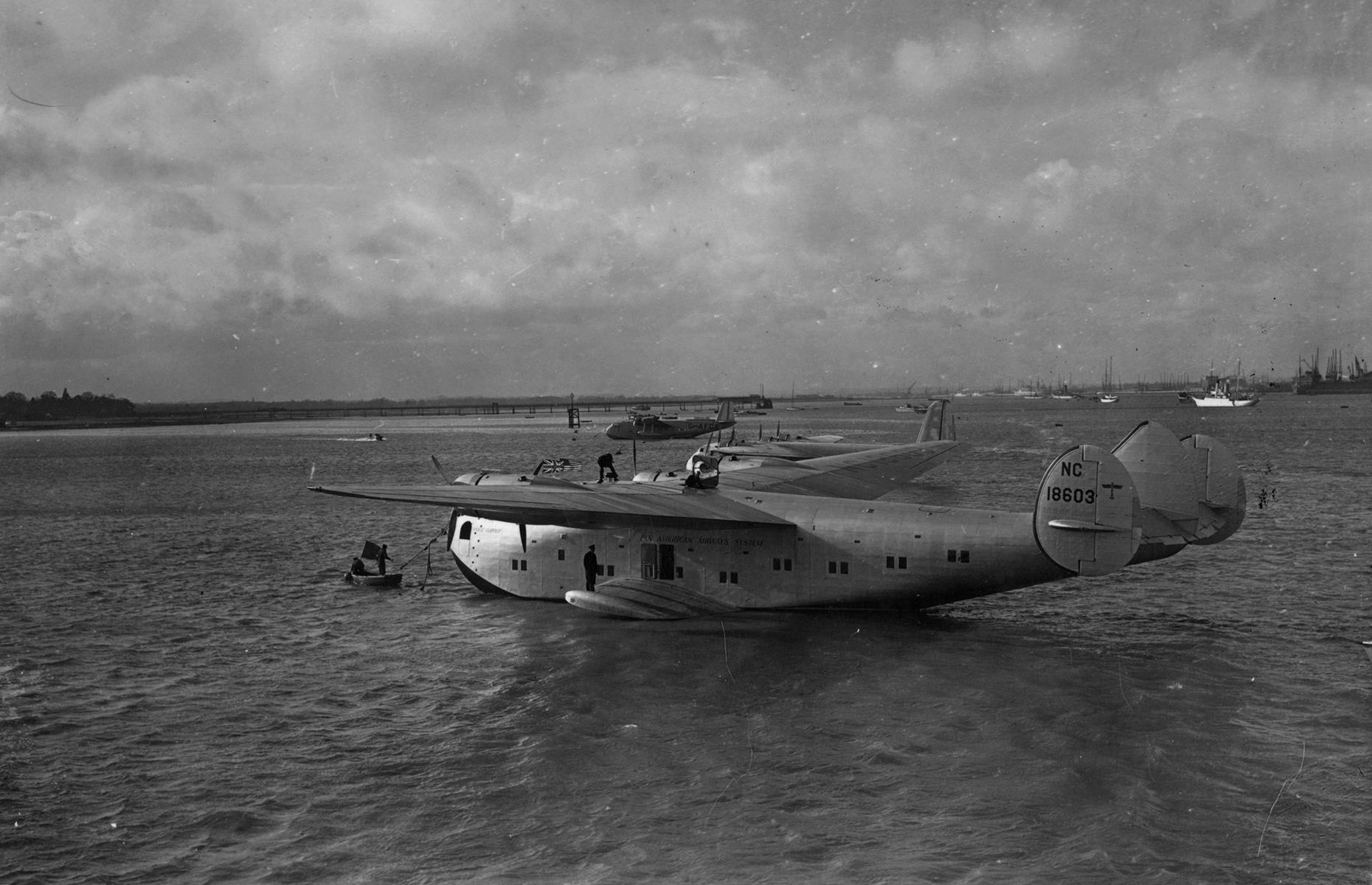 Slide 13 of 51: The 1930s also saw some of the earliest commercial flights across the Atlantic. Pan American Airways was one of the forerunners, transporting 21 passengers across the Atlantic in 1939. The Yankee Clipper aircraft or "flying boat", which undertook this journey, is pictured here in Calshot, Southampton, UK after the flight.
