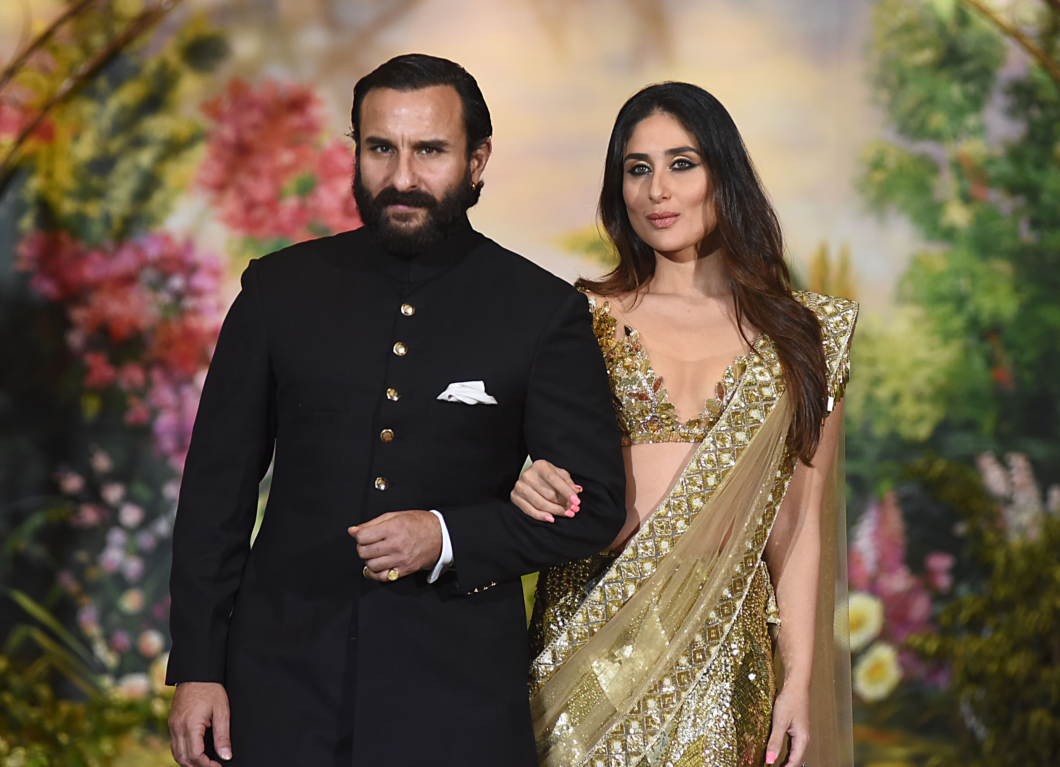 Slide 2 of 30: Indian Bollywood actors Saif Ali Khan and wife Kareena Kapoor Khan pose for a picture during the wedding reception of actress Sonam Kapoor and businessman Anand Ahuja in Mumbai late on May 8, 2018. (Photo by Sujit Jaiswal / AFP) (Photo credit should read SUJIT JAISWAL/AFP/Getty Images)