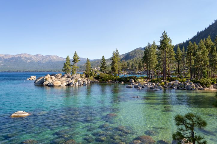 Slide 14 of 52: Stunning Lake Tahoe, ringed by trees and surrounded by snowy mountains in the distance, is one of North American's ancient lakes and has the distinction of being the deepest lake after Crater Lake.
