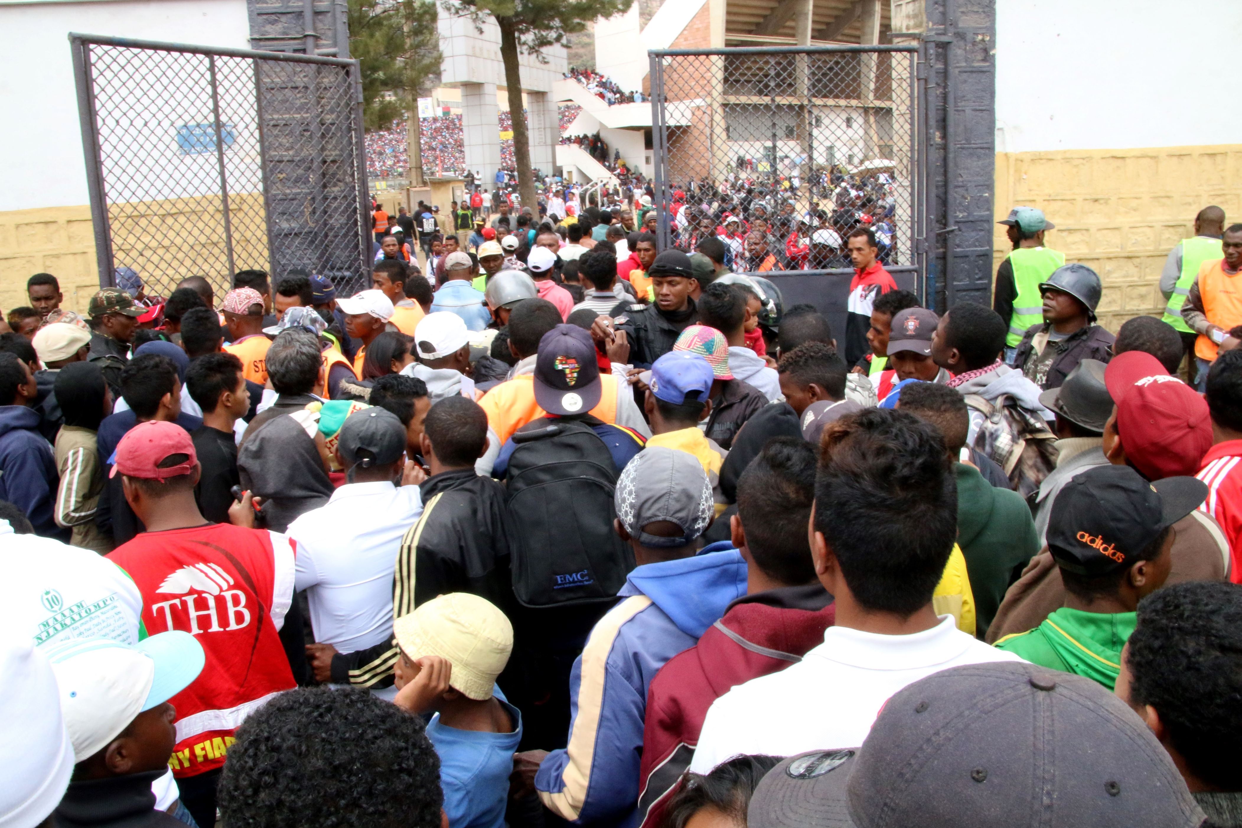 Malagasy people queue outside a football stadium waiting to enter and attend the African Cup of Nations qualifier match between Senegal and Madagascar on September 9, 2018 in Antananarivo, Madagascar. - At least one person was killed and nearly 40 were injured in a stampede ahead of an Africa Cup of Nations qualifier Sunday in which Madagascar hit back twice to draw 2-2 with Senegal. (Photo by Mamyrael / AFP)        (Photo credit should read MAMYRAEL/AFP/Getty Images)
