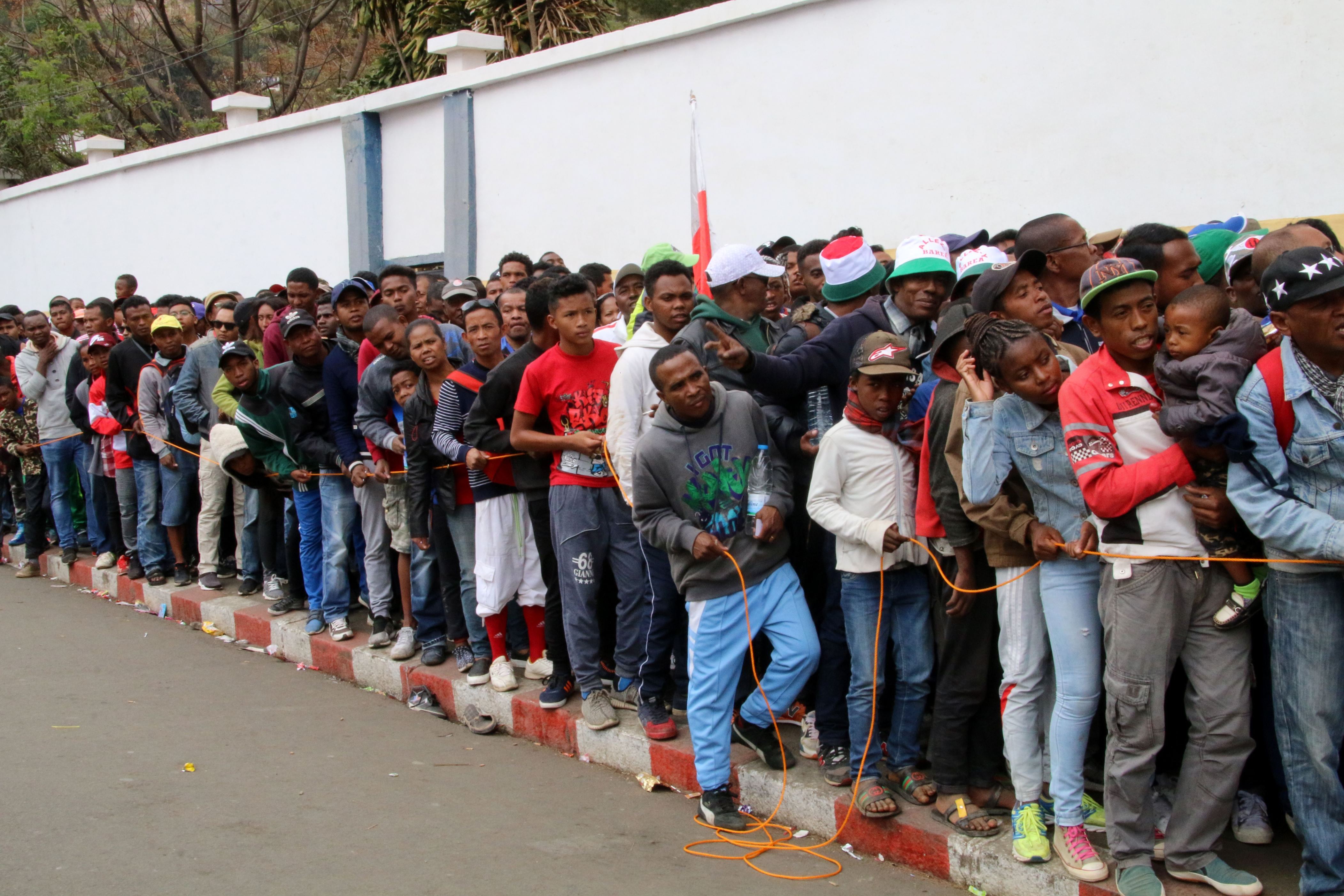 Malagasy people queue outside a football stadium waiting to enter and attend the African Cup of Nations qualifier match between Senegal and Madagascar on September 9, 2018 in Antananarivo, Madagascar. - At least one person was killed and nearly 40 were injured in a stampede ahead of an Africa Cup of Nations qualifier Sunday in which Madagascar hit back twice to draw 2-2 with Senegal. (Photo by Mamyrael / AFP)        (Photo credit should read MAMYRAEL/AFP/Getty Images)
