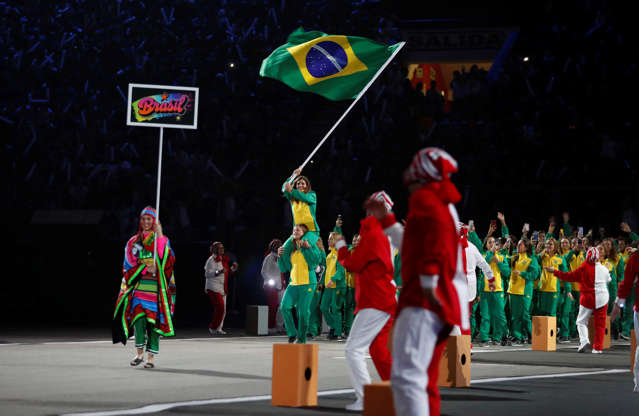 Slide 1 de 15: Brazil's athletes parade during the Opening Ceremony for the Pan American Games the Opening Ceremony for the the Pan American Games at the National stadium in Lima, Peru, Friday, July 26, 2019. (AP Photo/Fernando Vergara)