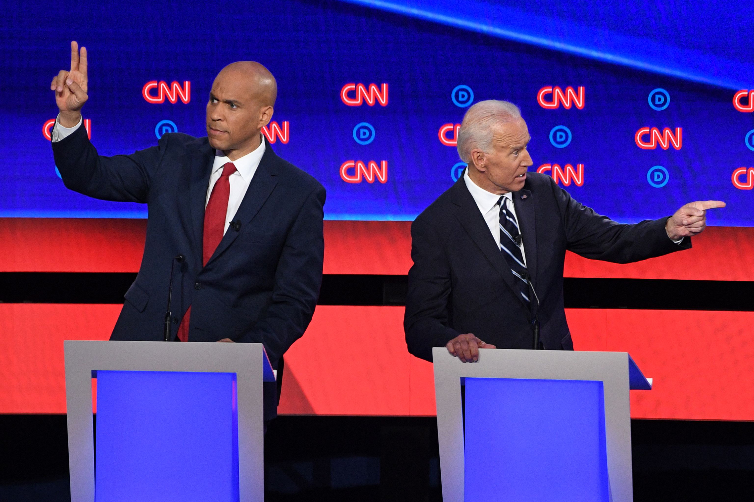 Slide 2 of 42: Democratic presidential hopefuls Former Vice President Joe Biden (R) and US Senator from New Jersey Cory Booker gesture during the second round of the second Democratic primary debate of the 2020 presidential campaign season hosted by CNN at the Fox Theatre in Detroit, Michigan on July 31, 2019.