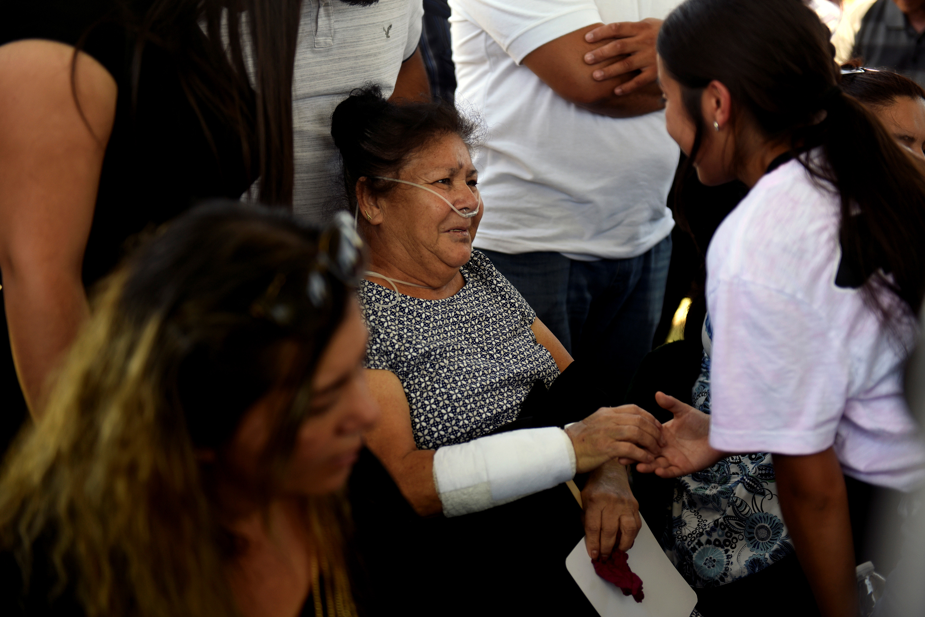 Slide 9 of 59: A young woman greets Nicholasa Velazquez, who was shot while shopping at Walmart, during a burial for her husband, Juan Velazquez, six days after a mass shooting at a Walmart store in El Paso, Texas, U.S. August 9, 2019. REUTERS/Callaghan O'Hare