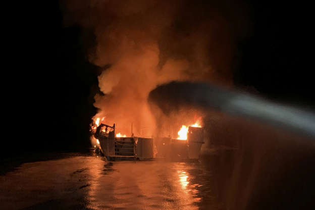 Slide 1 of 22: In this photo provided by the Ventura County Fire Department, VCFD firefighters respond to a boat fire off the coast of southern California, Monday, Sept. 2, 2019. The U.S. Coast Guard said it has launched several boats to help over two dozen people "in distress" off the coast of southern California. (Ventura County Fire Department via AP)