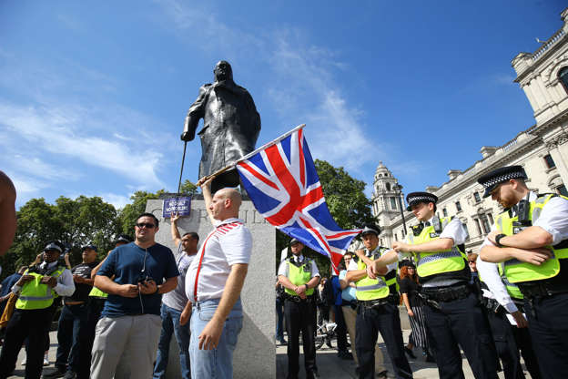 Slide 4 of 54: Pro-Brexit protesters at the Churchill statue in Westminster Square in London, as anti-Brexit protesters take part in the 'Let Us Vote' day of action, organised by Another Europe is Possible campaign group in central London to demonstrate against Prime Minister Boris Johnson's decision to suspend Parliament for up to five weeks before a Queen's Speech on October 14. (Photo by Gareth Fuller/PA Images via Getty Images)