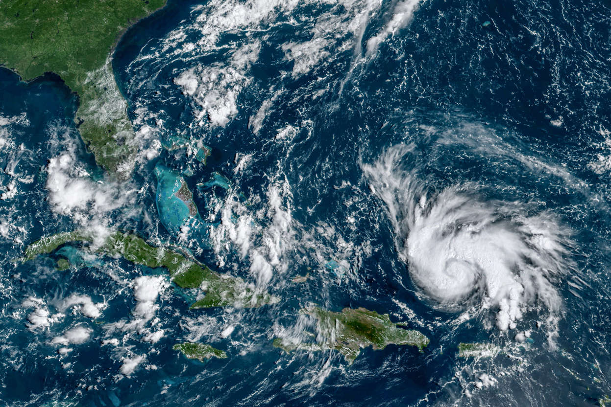 Slide 1 of 45: This GOES-16 satellite image taken Thursday, Aug. 29, 2019, at 14:20 UTC and provided by National Oceanic and Atmospheric Administration (NOAA), shows Hurricane Dorian, right, moving over open waters of the Atlantic Ocean. The U.S. National Hurricane Center said Dorian was expected to grow into a potentially devastating Category 3 hurricane before hitting the U.S. mainland late Sunday or early Monday somewhere between the Florida Keys and southern Georgia.