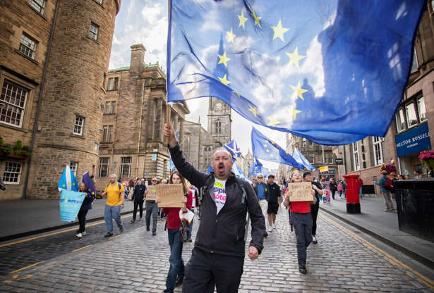 Slide 3 of 54: Protestors from the European Movement in Scotland hold a walking vigil on the Royal Mile, Edinburgh, to demonstrate against Prime Minister Boris Johnson temporarily closing down the Commons from the second week of September until October 14 when there will be a Queen's Speech to open a new session of Parliament. (Photo by Jane Barlow/PA Images via Getty Images)