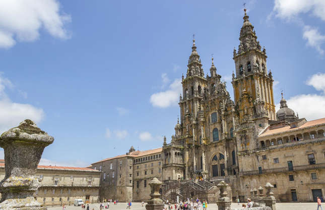 Slide 17 of 31: The grand finale marking the end of the Camino de Santiago pilgrimage route, the Cathedral of Santiago de Compostela is a striking landmark on the city's skyline. It was built over several centuries and completed in 1211. As such, it's a mix of mostly Romanesque architecture, with several Gothic and Baroque additions.