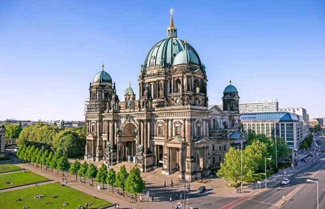 Slide 9 of 31: Despite its name, Berlin Cathedral has never been an actual cathedral as it's never been the seat of a bishop, but it's still a stunner. The Neo-Renaissance building has four towers and an impressive dome topped with a golden cross. Located on Berlin's Museum Island, the church was finished in 1905 and houses not only a place of worship but a museum and concert hall too. Plan your visit to Berlin with our top guide.