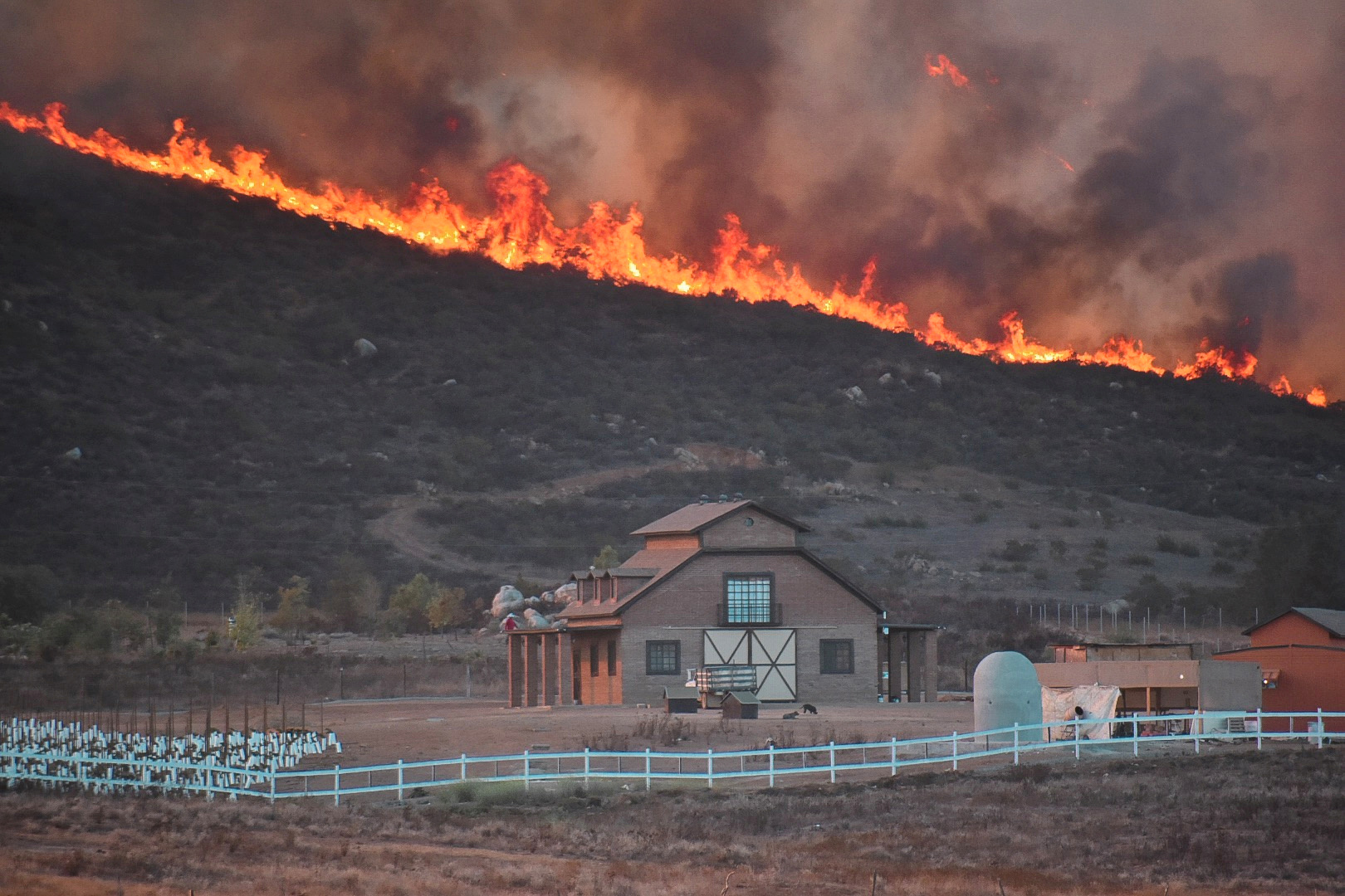 Slide 5 of 44: A fire burns in Valle de Guadalupe, Baja California, Mexico on Oct. 25, 2019 in this picture obtained from social media.