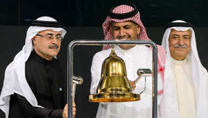 Ibrahim Abdulaziz Al-Assaf holding a microphone
