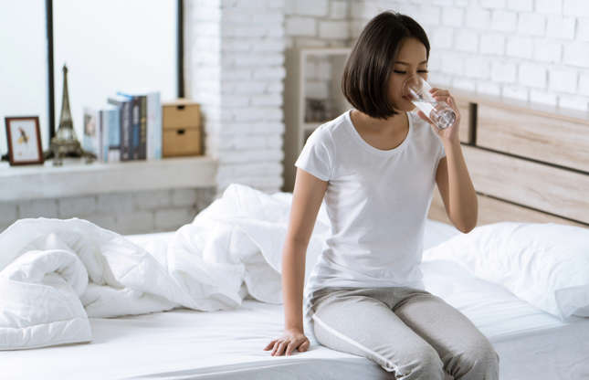 Slide 12 of 21: After a long night’s sleep, our body is dehydrated. Experts recommend starting the day off with a big glass of water. You’ll feel more alert and energetic all day long. Hydrating when you wake up also helps keep your skin looking youthful and can prevent wrinkles.