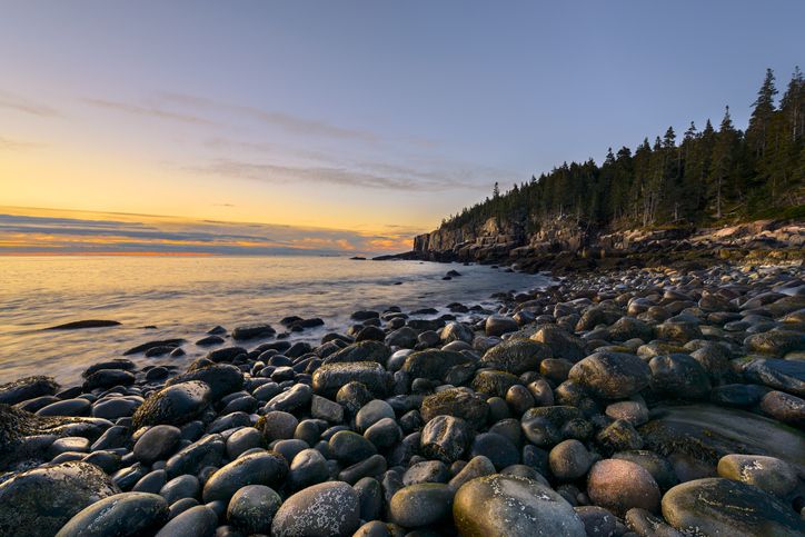 Slide 8 of 29: This photo may not be what many people think of when they hear the word "beach," particularly children who may associate the word with sandcastles. Indeed, you won’t have much luck writing your initials in the rocks, but with a sunrise view like this, who cares?