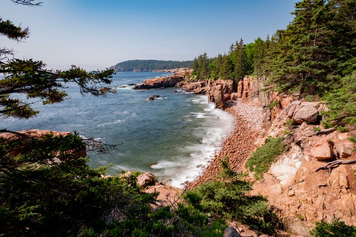 Slide 17 of 29: Mount Desert Island is one of several islands that are part of Acadia National Park. All of them offer ideal hiking for people who love to be near the water. This hiking trail offers tantalizing views that stretch to the horizon.