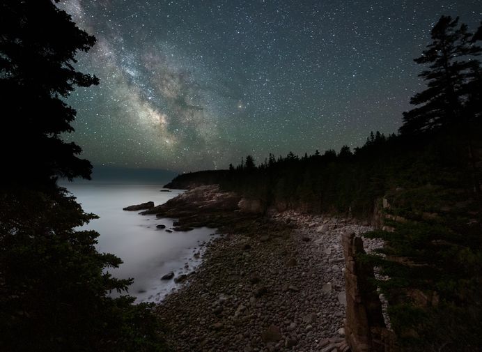 Slide 23 of 29: If you like to camp out and spend a few nights under the stars, Acadia National Park has got you covered — with stars! You may night be able to predict when you’ll have a perfect night with no clouds, but if you’re there at the right time, you can look up and see everything. This, of course, is a time-lapse photo, but you're guaranteed some breathtaking views of the cosmos.