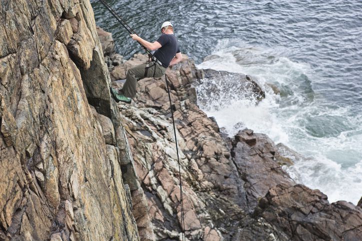 Slide 22 of 29: Acadia National Park offers hiking for people at every level of expertise, from the complete amateur to the highly seasoned. But for the more adventurous, there are lots of opportunities as well, like rock climbing and rapelling. You could be just like this guy on Otter Cliffs!
