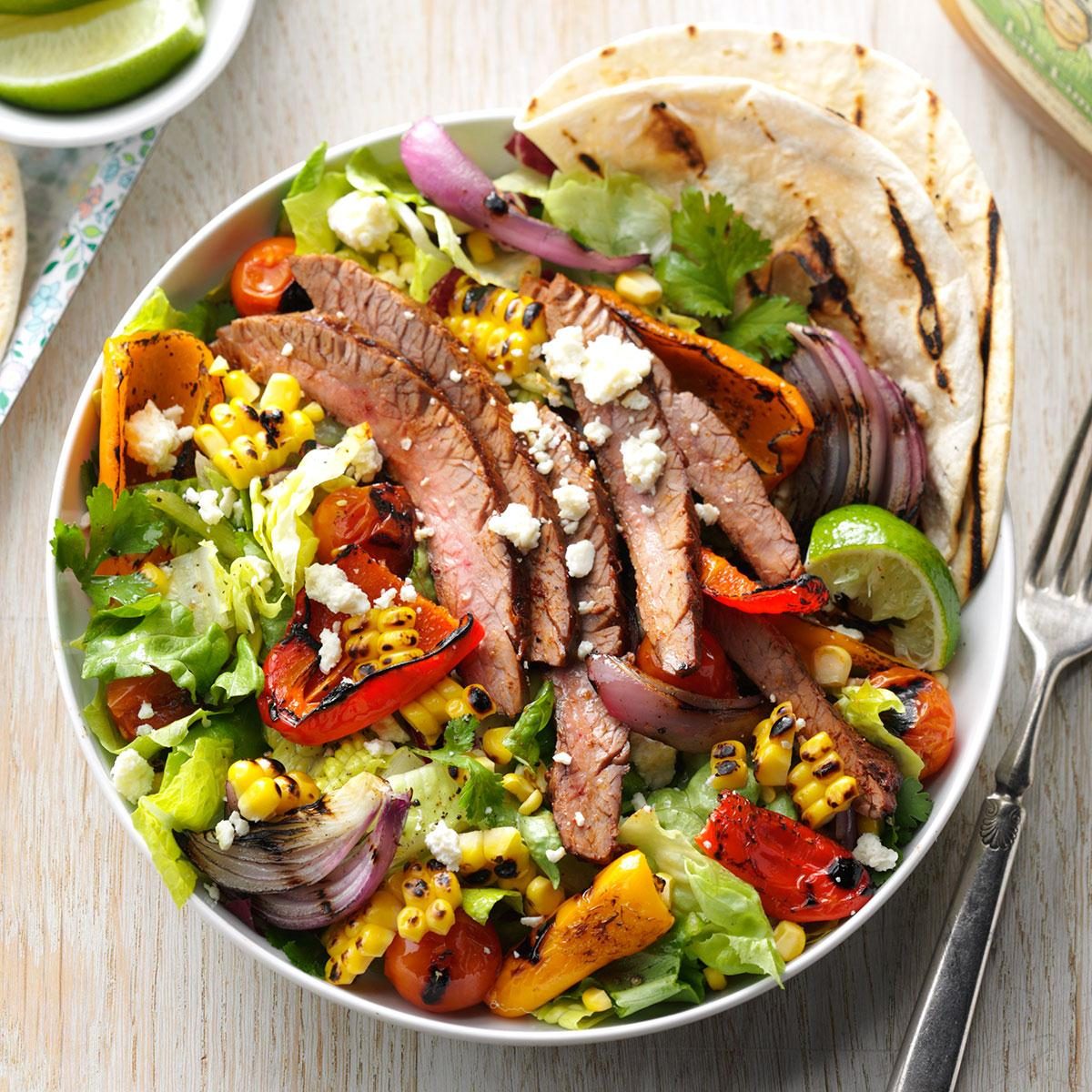 <p>Pull out the skewers and take a stab at grilling peppers, onions and corn for an awesome steak salad that’s all summer and smoke. —Taste of Home Test Kitchen, Milwaukee, Wisconsin</p> <div class="listicle-page__buttons"> <div class="listicle-page__cta-button"><a href='https://www.tasteofhome.com/recipes/fajita-in-a-bowl/'>Go to Recipe</a></div> </div>