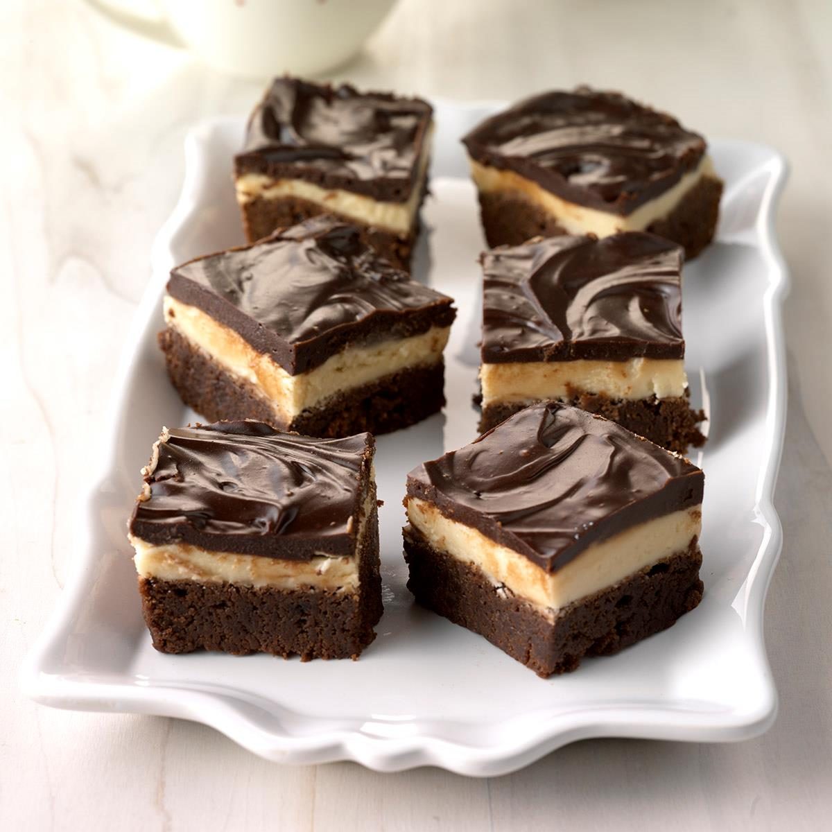 <p>My husband and I are big fans of Irish cream, so I wanted to incorporate it into a brownie. I started with my mom's brownie recipe, then added frosting and ganache. This decadent recipe is the result, and we really enjoy them! —Sue Gronholz, Beaver Dam, Wisconsin</p> <div class="listicle-page__buttons"> <div class="listicle-page__cta-button"><a href='https://www.tasteofhome.com/recipes/fudgy-layered-irish-mocha-brownies/'>Go to Recipe</a></div> </div>