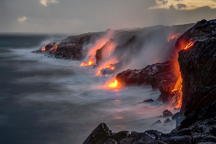 <p>As lava from Kilauea flows downhill and meets the sea, it slowly extends the island's shoreline. Over 100 acres of new oceanfront land was created in Hawaii Volcanoes National Park from Kilauea's eruptions.</p>