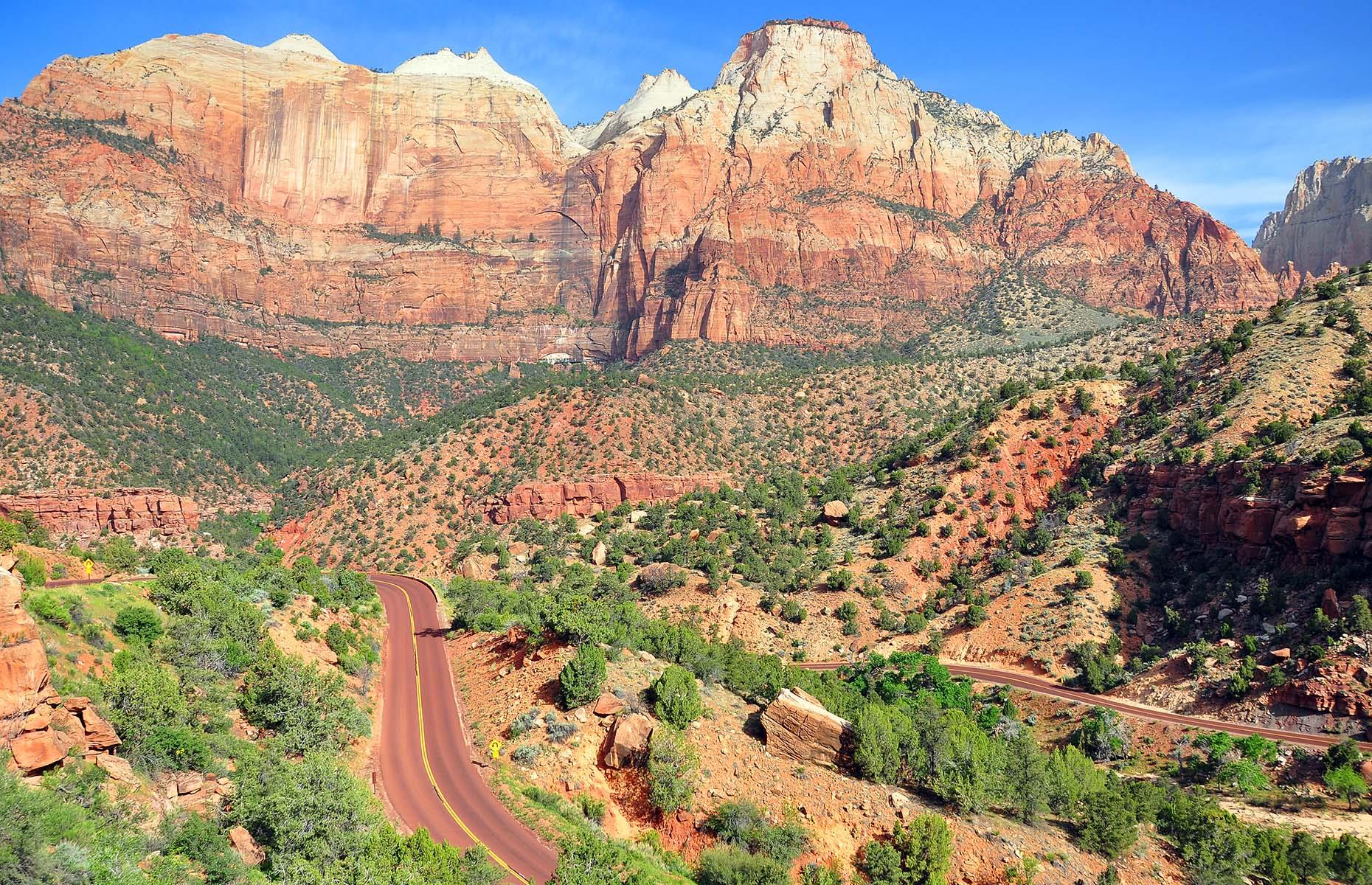 <p>Winding its way through one of the state's most famous landscapes, the <a href="https://utah.com/scenic-drive/zion-national-park">Zion Scenic Byway</a> follows Utah State Route 9, from La Verkin to the south entrance of the Zion National Park. The drive then takes in towering mesas, hoodoos and sandstone cliffs as it follows the Zion-Mount Carmel Highway to the park's east entrance. Break up the drive with a hike – explore the ghost town of Grafton, an abandoned spot featured in 1969 western <em>Butch Cassidy and the Sundance Kid</em>.</p>