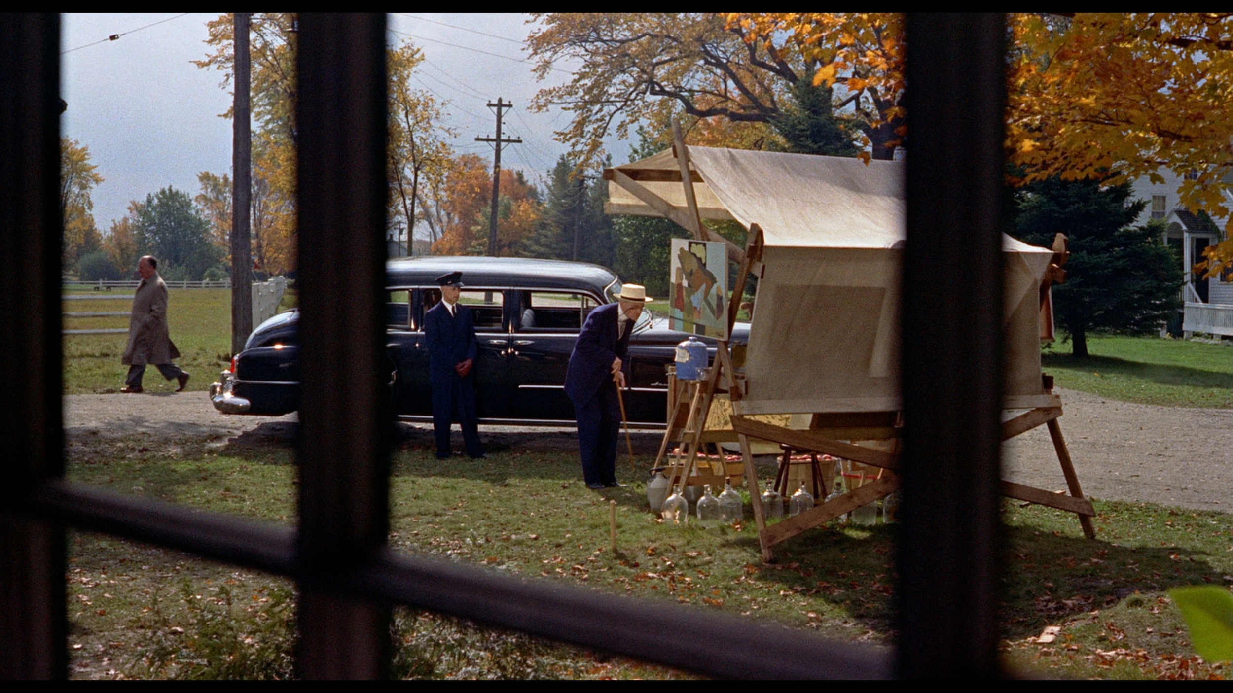 <p>One of Hitchcock’s 1955 cameos is front-and-center. The other decidedly isn’t. Hitchcock is way in the background walking down the street but by this point, the films were in color and shot on better film stock, so you can tell it’s him.</p>