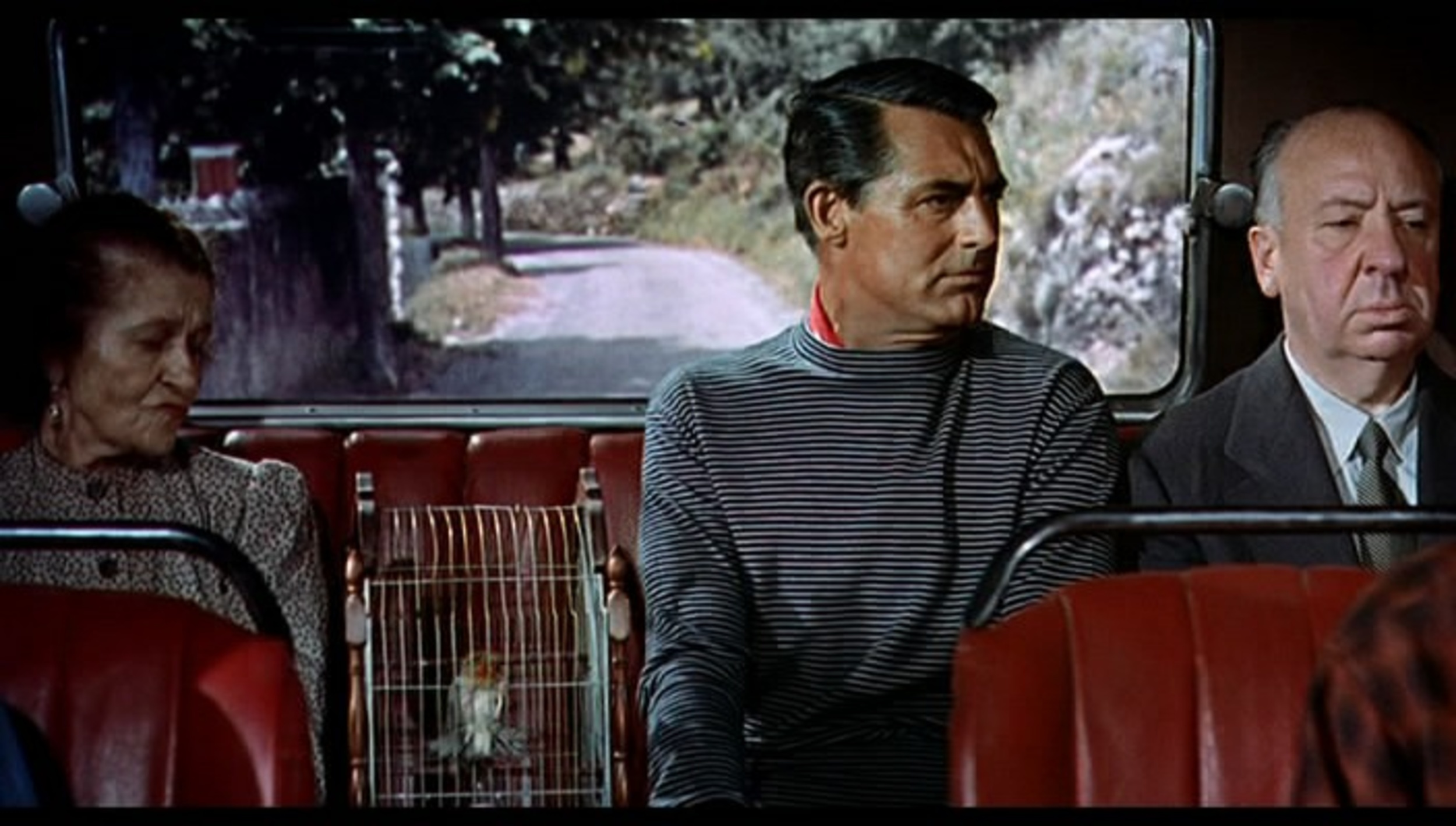 <p>By 1955 Hitchcock’s cameos were clearly a “thing.” In “To Catch a Thief” the camera literally pans over to show Hitch just sitting on a bus next to Cary Grant. On the other side of Grant, by the way, is a woman with a birdcage containing two birds.</p>