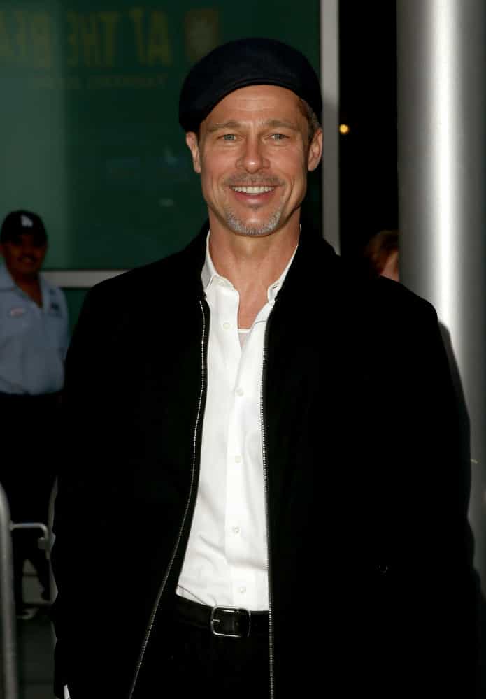 Brad Pitt and woman posing for a picture