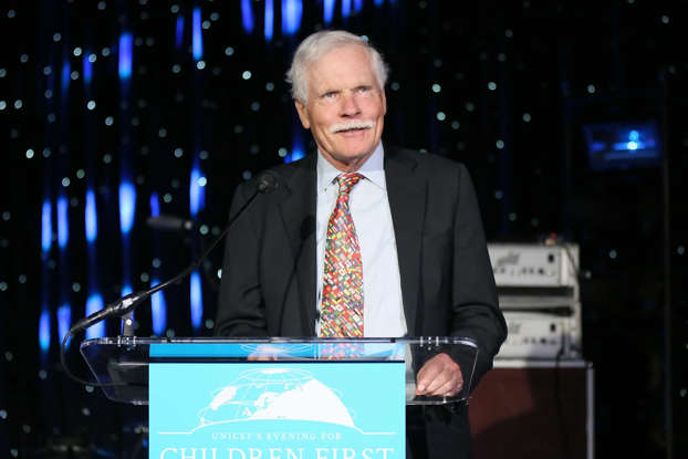 Ted Turner wearing a suit and tie